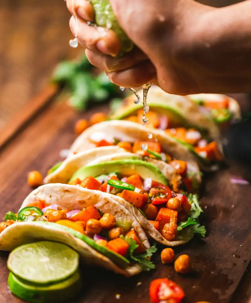 Tacos filled with beans and fresh toppings